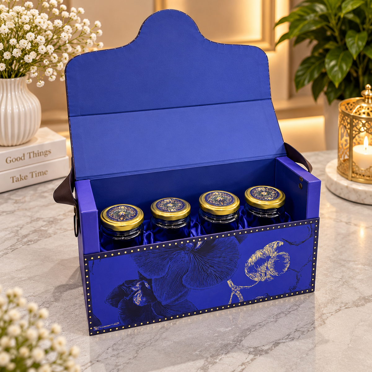 Open royal cobalt blue Kappa Board dry fruit gift box with four 350 ml jars